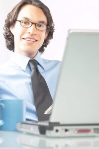 Businessman using gray laptop computer